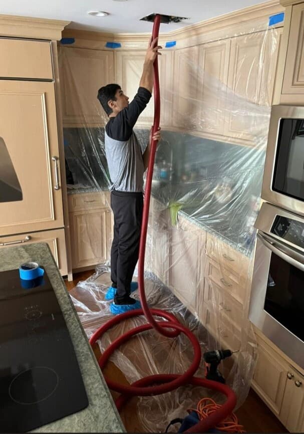 Professional air duct cleaning technician working